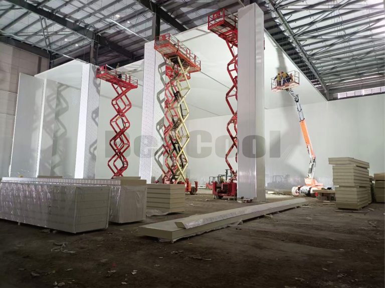 cold room installation with insulated panels and lifting equipment